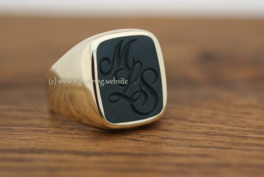 Gold ring with gemstone and engraving